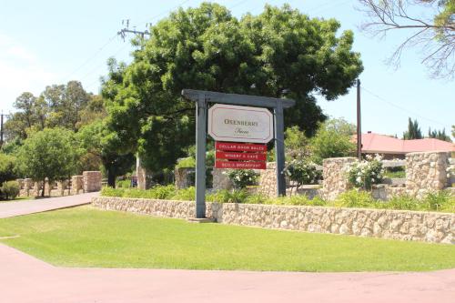 a sign for a cemetery in a grass field at Oxenberry Farm in McLaren Vale