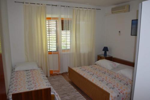 Postel nebo postele na pokoji v ubytování Apartman Linda
