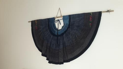 a black curtain hanging on a white wall at Pink Tulip Hoi An in Hoi An