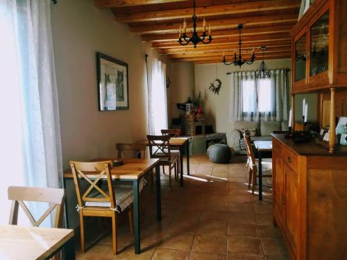 a dining room with tables and chairs and a kitchen at Lo Cel De Tolo in Toló