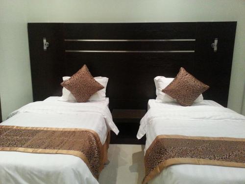 Cama o camas de una habitación en Elaf Suits