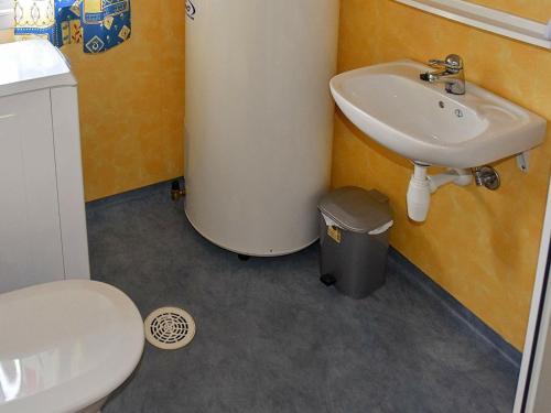 a bathroom with a toilet and a sink at Three-Bedroom Holiday home in Utvik 1 in Reed