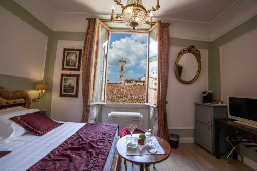 a bedroom with a bed and a window with a view at Stanze del David Place in Florence