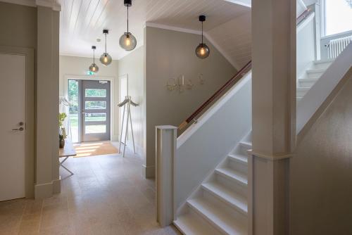 a hallway with stairs in a home with lights at Arkösunds Hotell in Arkösund