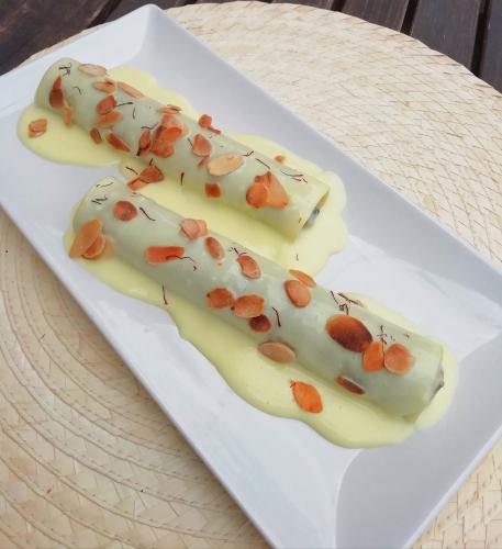 two pieces of food with nuts on a white plate at Lo Cel De Tolo in Toló