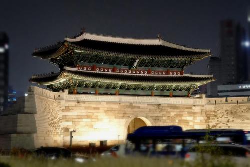 a large building with a chinese tower on top of it at Hotel Lumia Myeongdong in Seoul