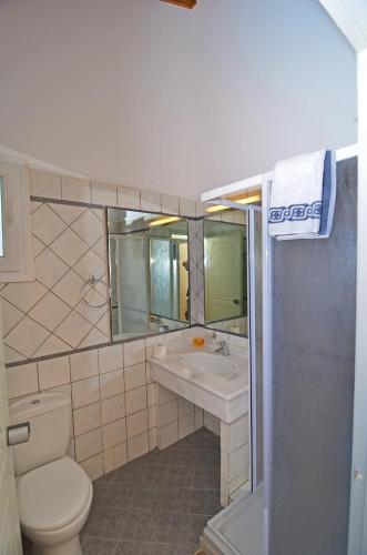 a bathroom with a toilet and a sink at Al Mare Hotel in Tsilivi