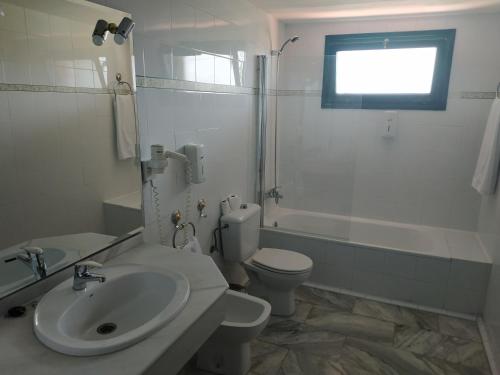 a bathroom with a sink and a toilet and a shower at Sabiñanigo Camp & Hotel in Sabiñánigo