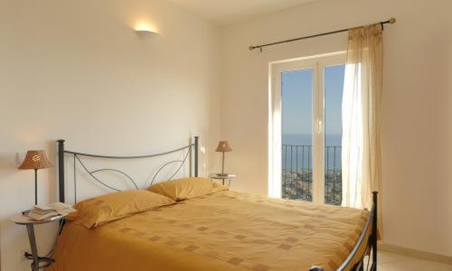 a bedroom with a bed with a large window at CASA VACANZE SANTI in Pietra Ligure