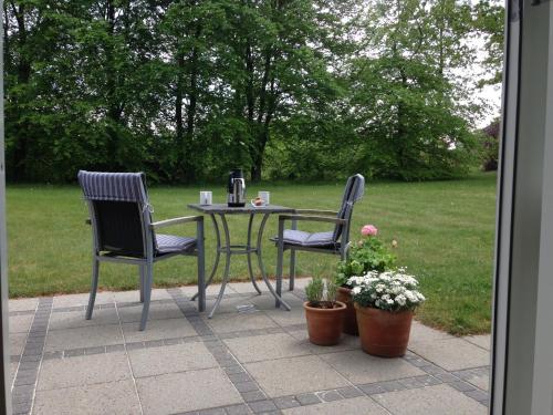 a table and two chairs sitting on a patio at Jensens B&B in Egtved