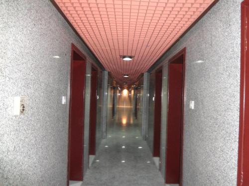 a hallway of an office building with a red ceiling at Top Hotel Apartments in Al Ain