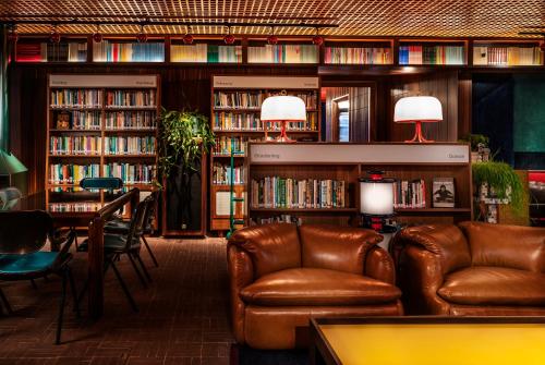 a living room filled with furniture and a book shelf at The Standard London in London