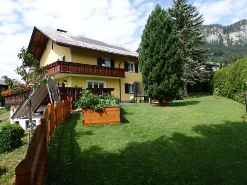 a house with a fence and a yard at Apartments Haus Steinbock in Tauplitz