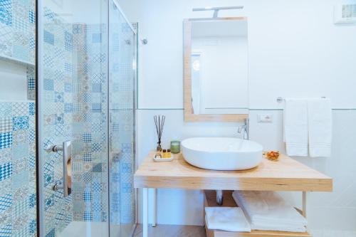 a bathroom with a sink and a glass shower at Chez Rosa - Cozy sea view openspace - 10mins from Belmond Caruso Ravello in Ravello