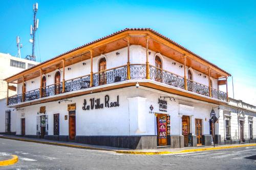 a white building with a balcony on the side of it at Le Foyer Arequipa in Arequipa