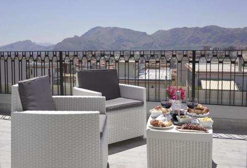 Un patio con dos sillas y una mesa con comida. en THE VIEW, en Palermo