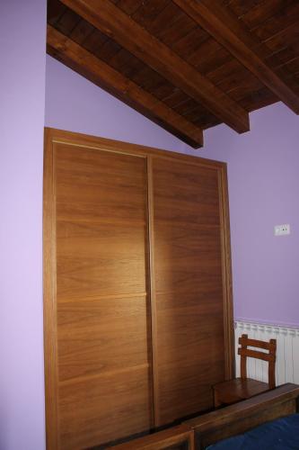 a wooden closet in the corner of a bedroom at Nekasenea II in Garísoain