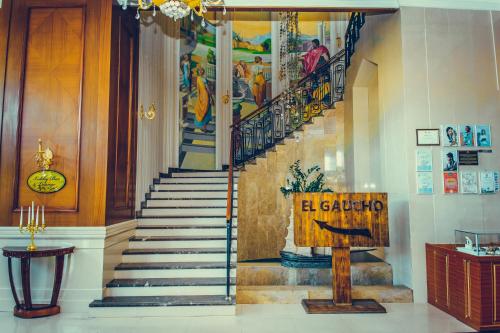 a staircase in a building with a painting on the wall at Diplomat Hotel by AG Hotels Group in Astana