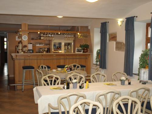 a restaurant with tables and chairs and a bar at Apartmány Rosalka in Stará Oleška