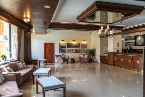 a lobby of a hospital with couches and tables at Hotel Tatra in Zakopane