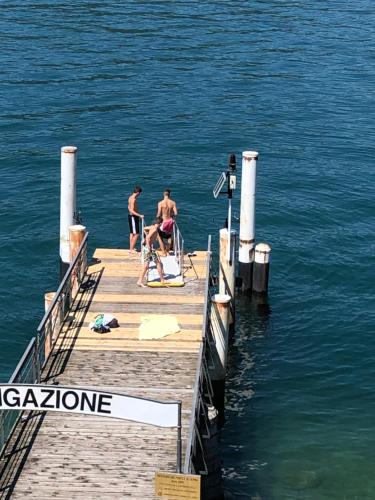 a group of people on a dock in the water at A Dream On The Lake in Lierna