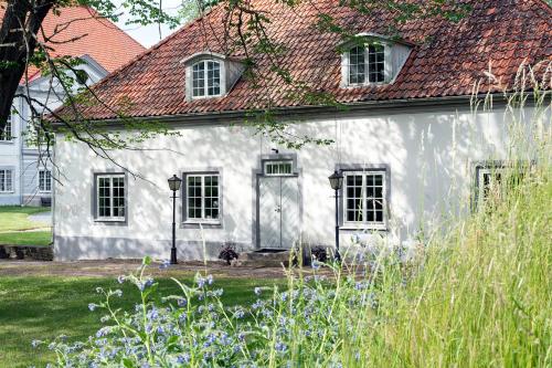 a white house with a red roof at Västanå Slott in Gränna