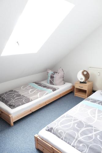 two beds sitting next to each other in a room at Ferienwohnung Haus Schmitt in Winterberg