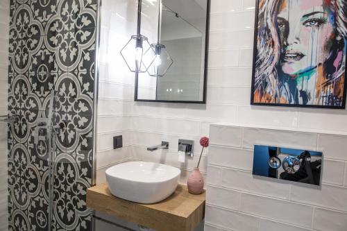 a bathroom with a white sink and a mirror at Reverence Boutique Hotel in Varna City