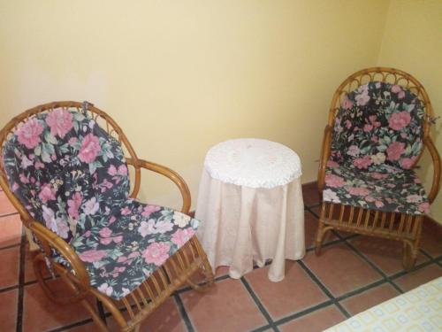 two chairs and a table with a table cloth at La Posada de Eustaquio in Canjáyar