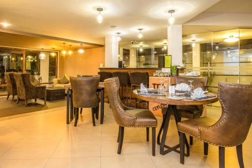 a restaurant with a table and chairs and a bar at Viyana Boutique Hotel in Kandy