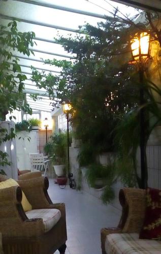 a patio with two couches and a tree at Luxury B&B IL Sogno in Cerignola