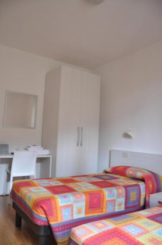 a hotel room with two beds and a kitchen at Albergo Bellavista in Chiusi della Verna