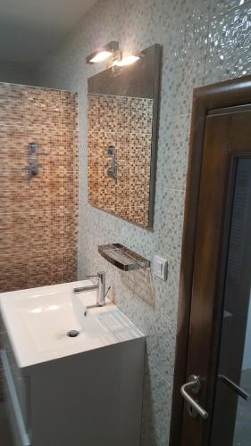 a bathroom with a sink and a mirror at Sunshine Dreams Villa Jahorina in Jahorina