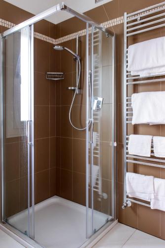 a shower with a glass door in a bathroom at Residence Millecento in Cesenatico