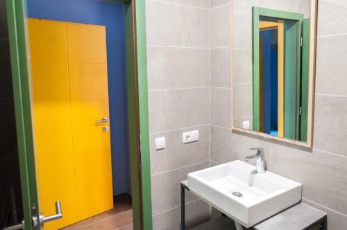 a bathroom with a sink and a mirror at Ura Hostel in Prizren