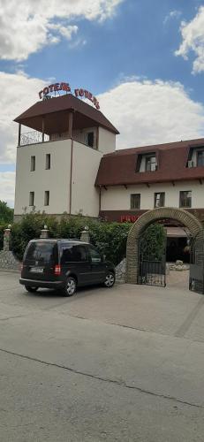 a black van parked in front of a building at Stara Vezha Hotel in Boryspilʼ