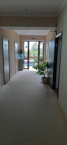 an empty hallway with a potted plant in a building at Stara Vezha Hotel in Boryspilʼ