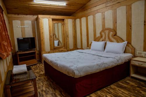 Postel nebo postele na pokoji v ubytování JJS Cottages