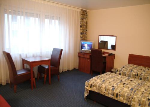 Телевизор и/или развлекательный центр в City Hotel Frankfurt