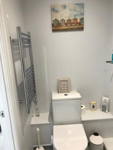 a bathroom with a toilet a sink and a mirror at Holden House in Shardlow