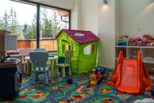 a childs play room with a table and a play house at Hotel Tatra in Zakopane