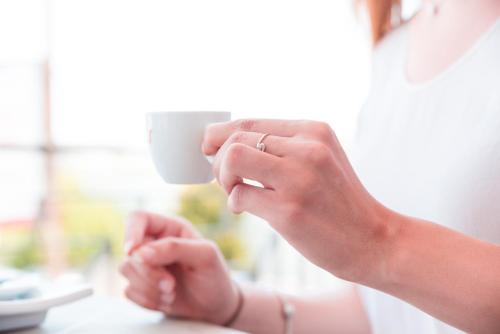 a woman holding a cup with her hands at kamilia guestrooms in San Cassiano
