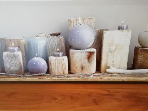 a group of wood blocks and candles on a table at La Villa Bel Ange Hotel in Saint-Philibert