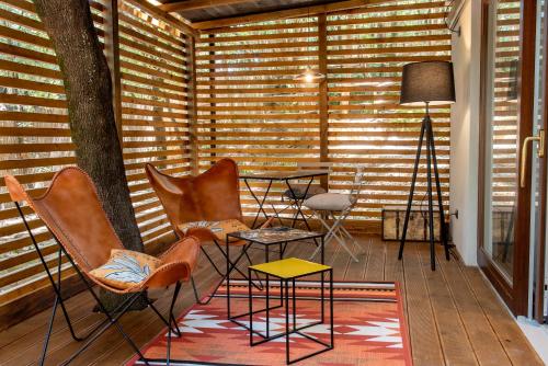 a room with chairs and a table and a tree at Camping Village Santapomata in Castiglione della Pescaia