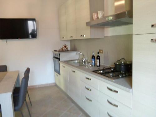 a kitchen with a sink and a stove top oven at Casa per vacanze in Meana di Susa in Meana di Susa