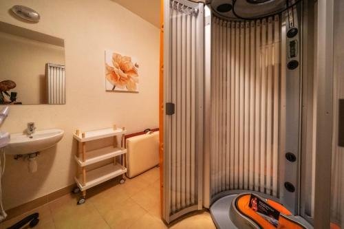 a small bathroom with a shower and a sink at Hotel Tatra in Zakopane