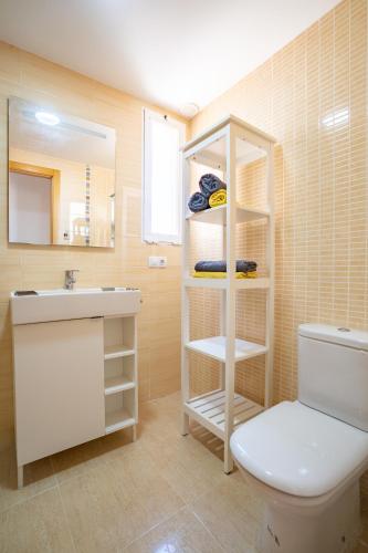 a bathroom with a toilet and a sink and a mirror at Ideally Located Holiday Apartment in Moncófar