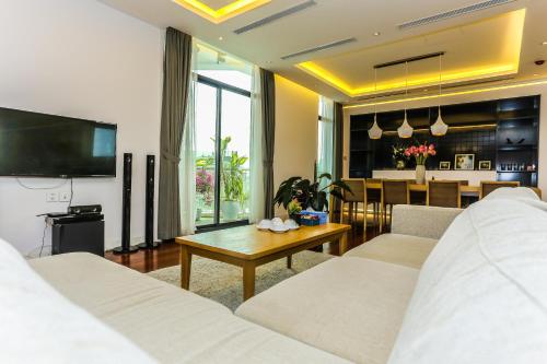 a living room with a couch and a table at HNC Premier Hotel & Residences in Hanoi