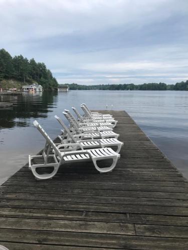 a row of white boats lined up on a dock at Beachside on Lake Muskoka in Port Carling
