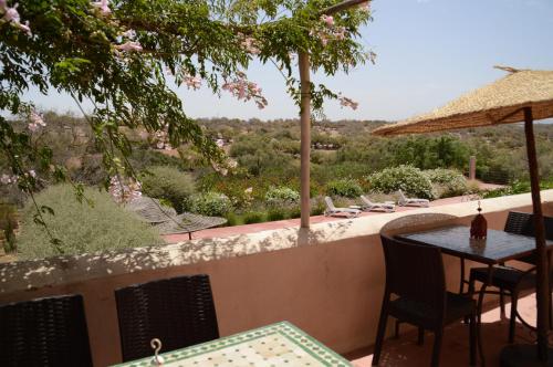 a patio with a table and chairs and a view at Dar Essaada in Essaouira